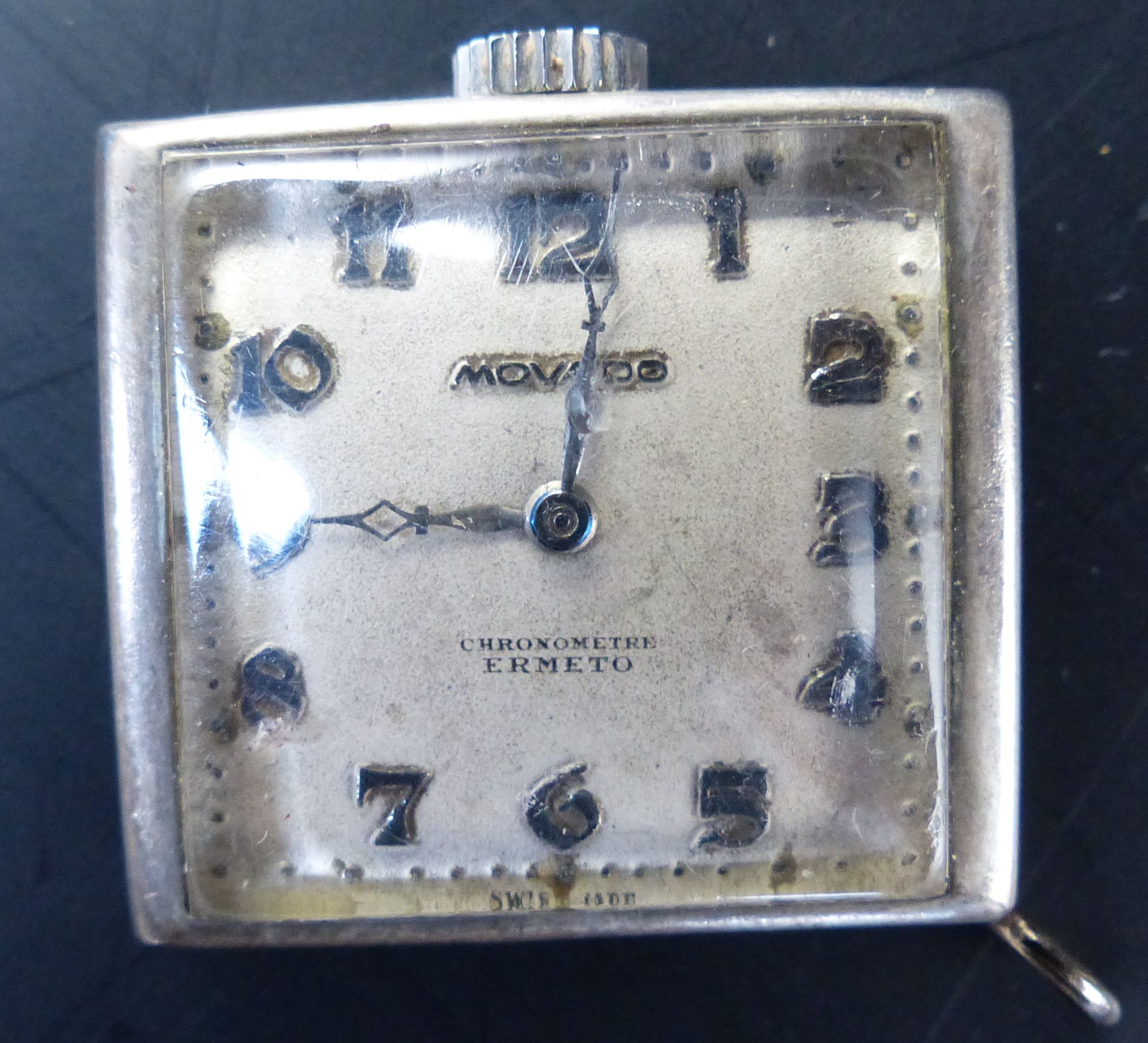 A ladys 1920s 18ct gold square dial wrist watch, 21mm, gross 14.8 grams and a Movado watch